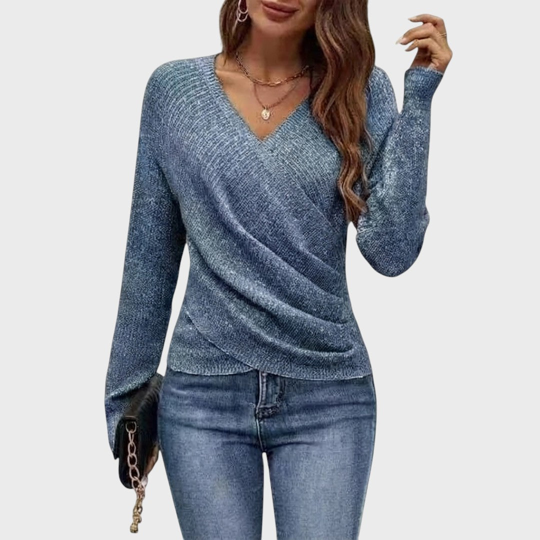 Blue structured V-neck pullover with long sleeves and draped wrap-style front.