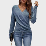 Blue structured V-neck pullover with long sleeves and draped wrap-style front.