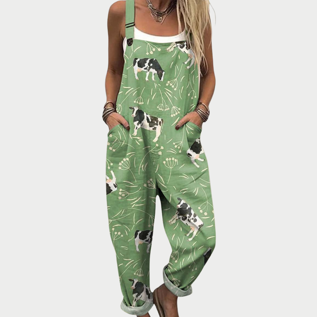 Loose-fit printed overalls, green with cow print, adjustable straps, wide legs