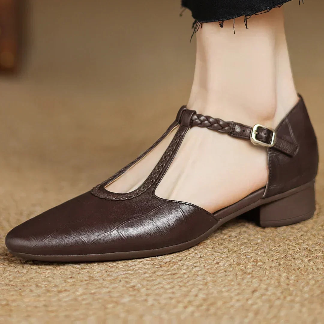 Brown leather pointed-toe flat shoe with braided ankle strap and gold buckle