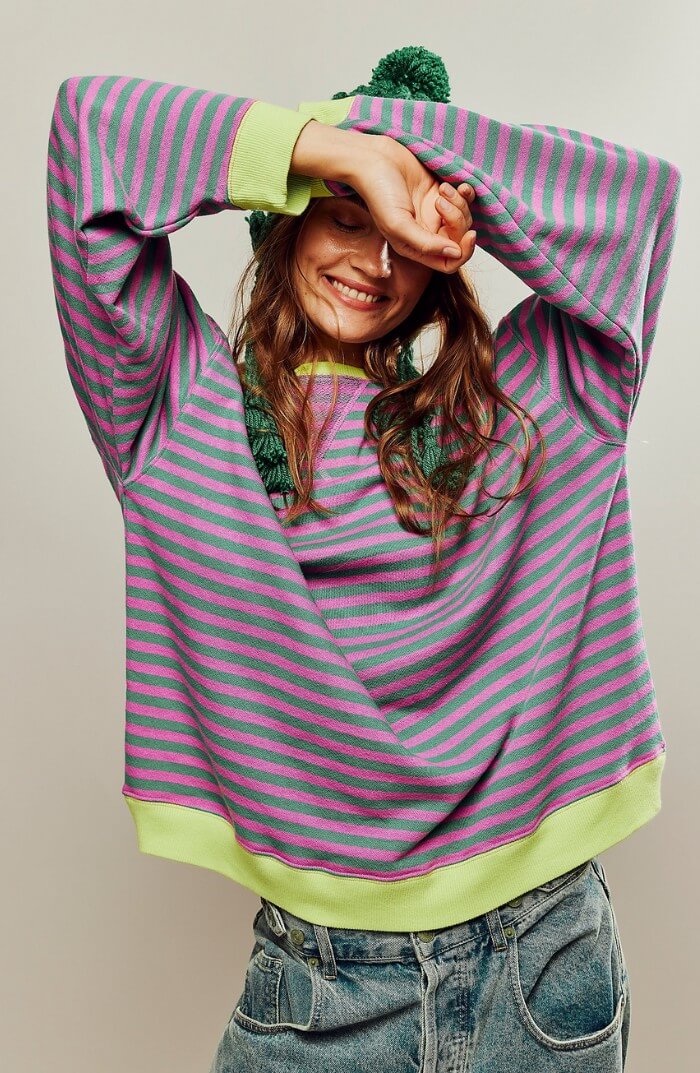 Green and pink striped relaxed pullover with neon yellow cuffs and long sleeves