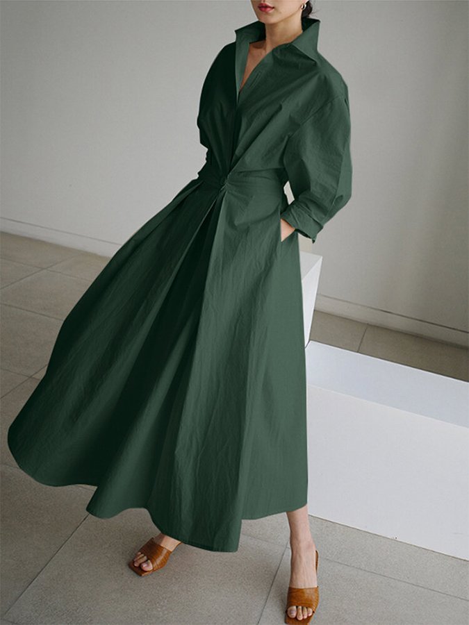 Dark green long wrap-style dress with puff sleeves and tied waist, flowing full skirt