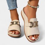 Beige/cream orthopedic sandal with double gold-tone buckle strap, open toe.