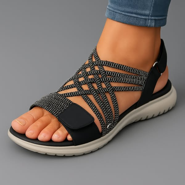 Orthopedic sandal in black with woven upper straps, open toe, and thick sole.