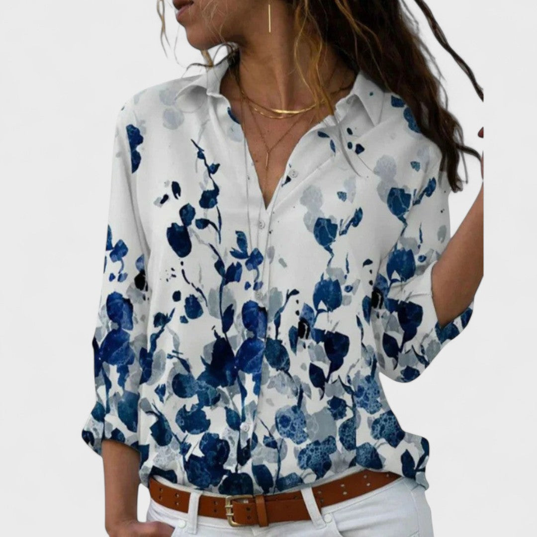 Elegant button-up blouse in light blue with navy abstract floral print, collared