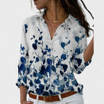 Elegant button-up blouse in light blue with navy abstract floral print, collared