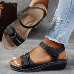 Black orthopedic comfort sandals with hook-and-loop straps and cushioned wedge sole