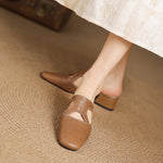 Tan natural leather mule flats with low block heel and T-strap cutout detail