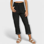 Cropped black pants with pleats, button fly, and side pockets