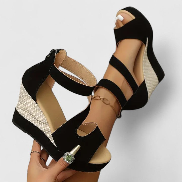 Black open-toe wedge sandals with ankle strap and crisscross cutout bands