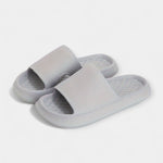 Light gray textured slide sandals with wide strap and thick cushioned sole