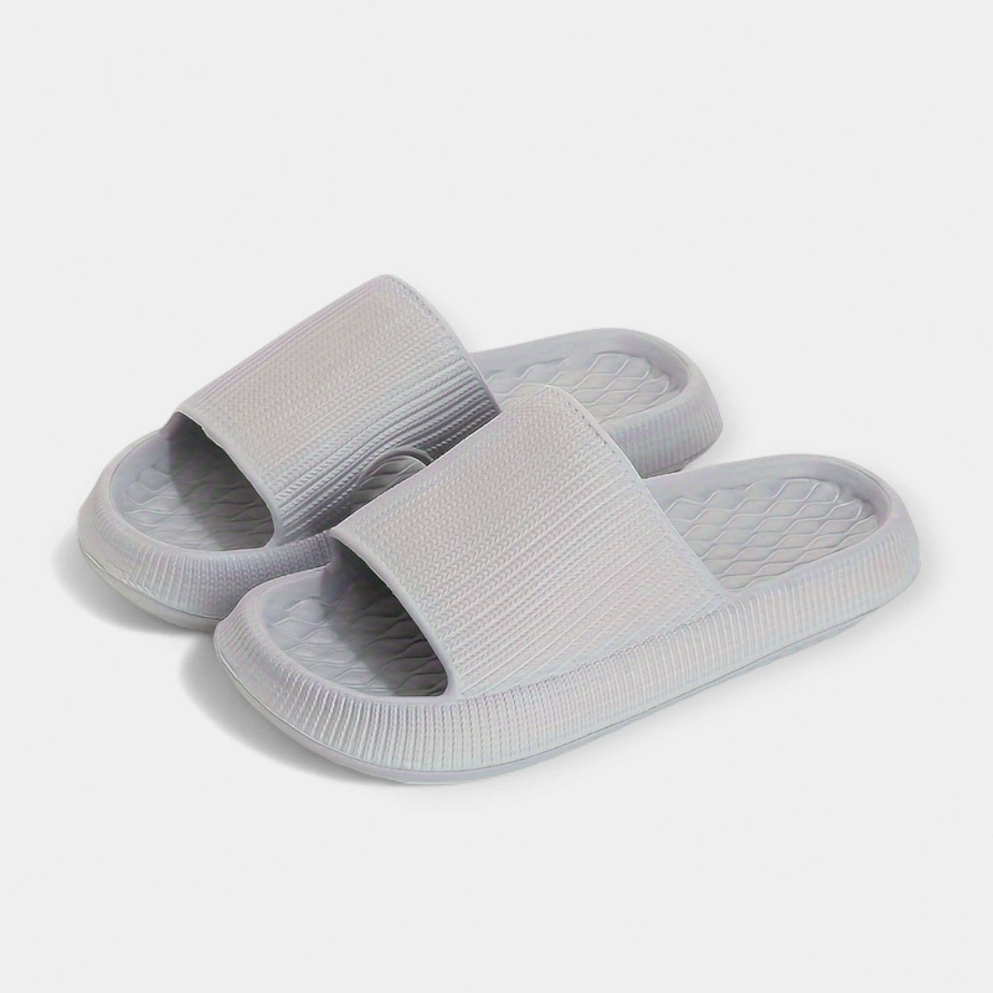 Light gray textured slide sandals with wide strap and thick cushioned sole