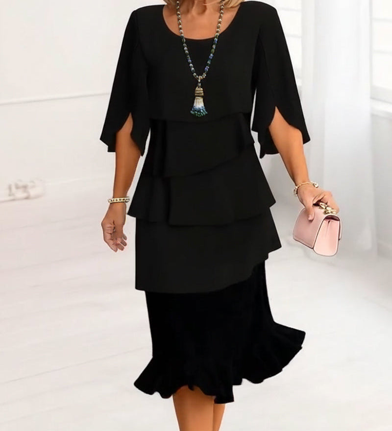 Black tiered ruffle midi dress with elbow-length cape sleeves and layered tiers