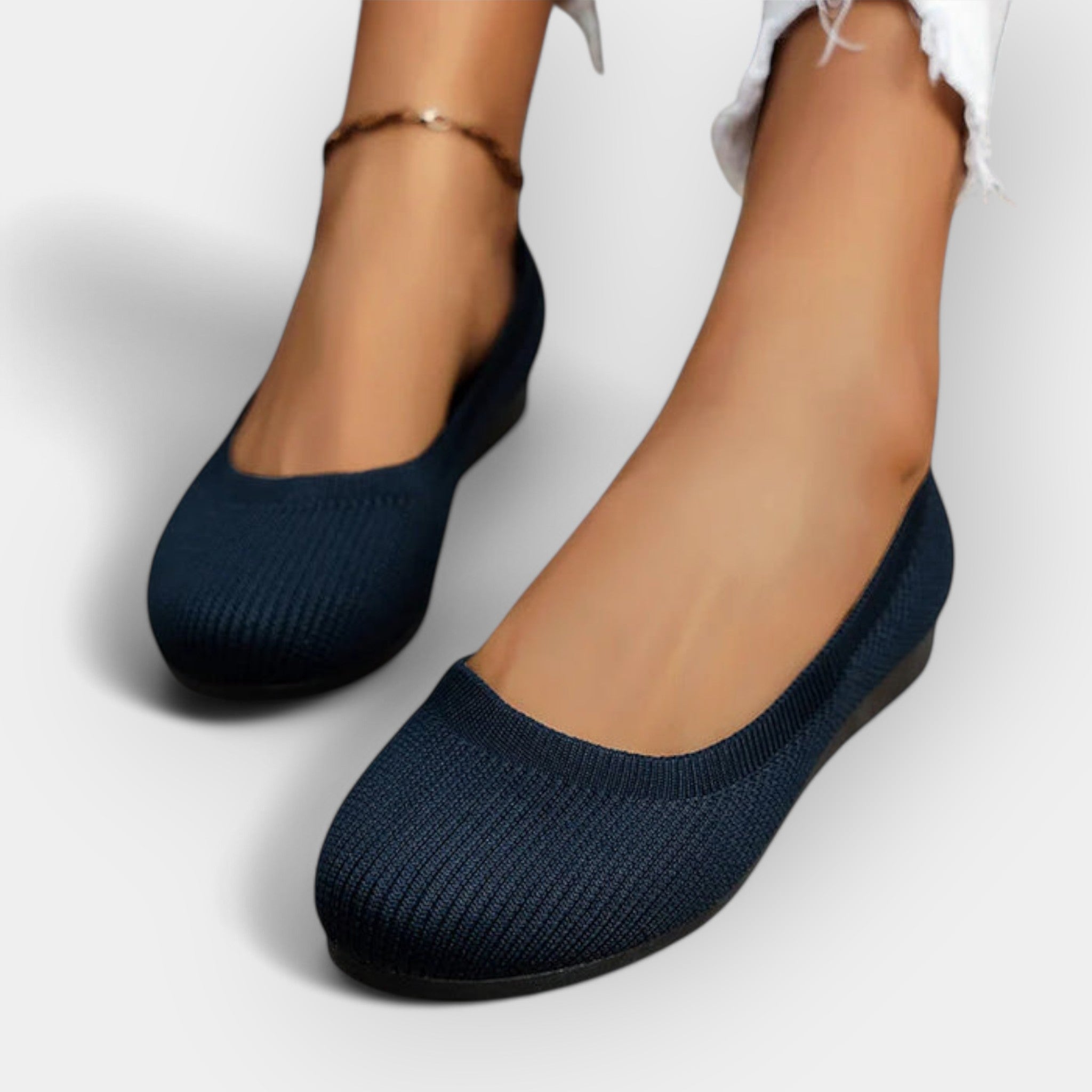 Navy knit slip-on ballet flats with rounded toe and flat sole