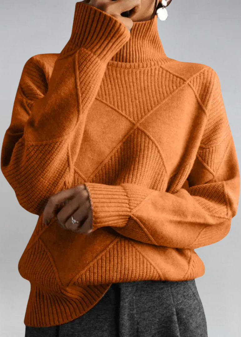 Rust orange high-neck sweater with ribbed turtleneck and diagonal knit panel detail.
