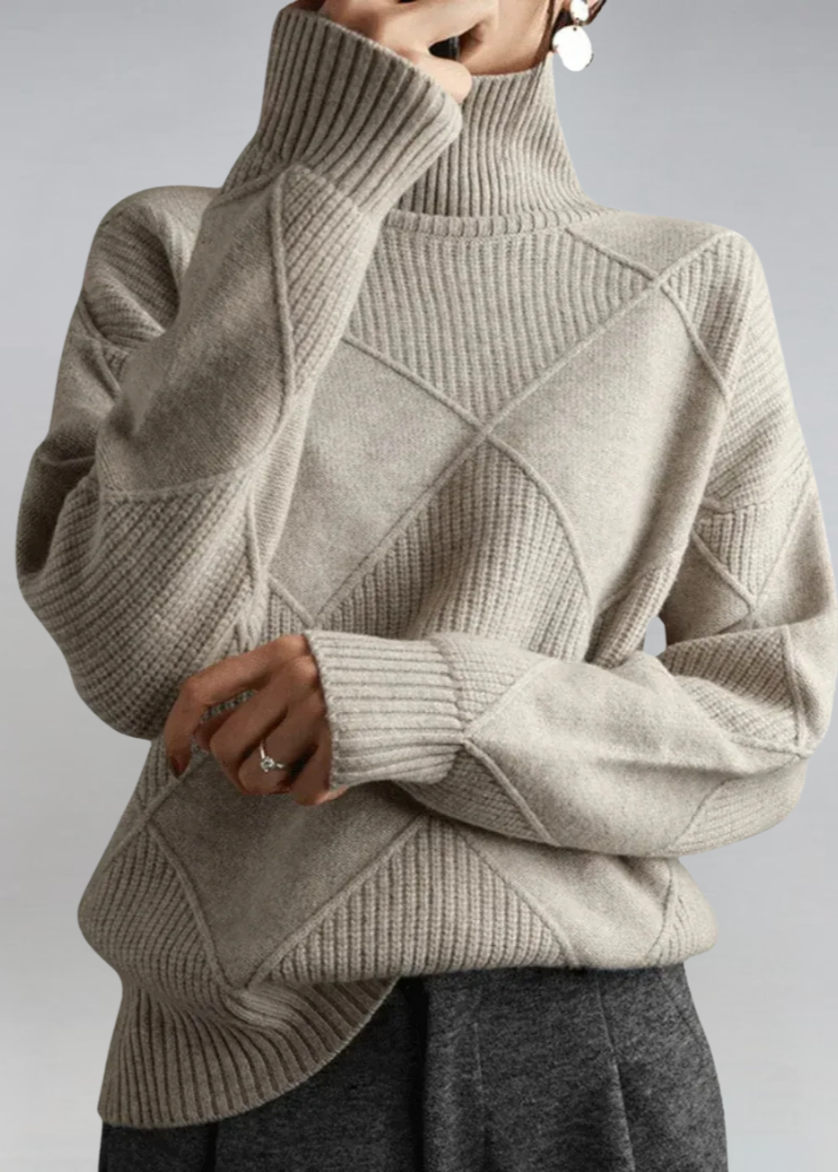 Beige high-neck sweater with ribbed turtleneck and diagonal knit panel detail.