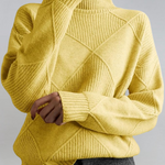 Yellow high-neck sweater with ribbed turtleneck and diagonal knit panel detail.