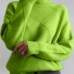 Lime green high-neck sweater with ribbed turtleneck and diagonal knit panel detail.