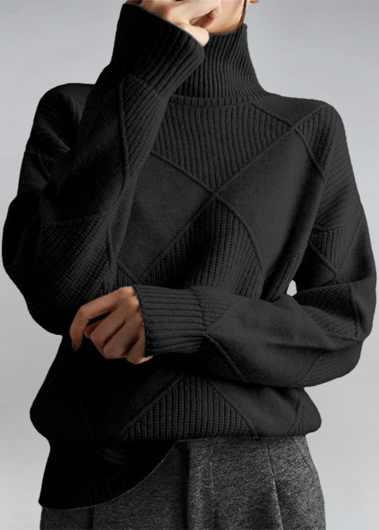 Black high-neck sweater with ribbed turtleneck and diagonal knit panel detail.