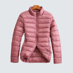 Pink puffer jacket with full front zipper and high stand collar, long sleeves.