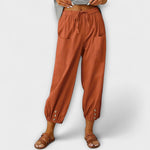 Rust brown harem pants with elastic waist and side cargo pockets