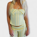 Sleeveless striped halter crop top and matching high-waist trousers in light yellow and pale blue
