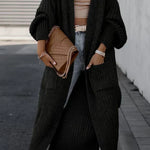Black long knit cardigan with textured knit, open front, and side pockets