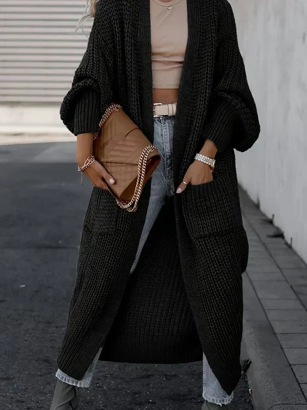 Black long knit cardigan with textured knit, open front, and side pockets