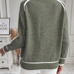 Olive green knit sweater, back view; white contrast stripe edging on shoulders and hem