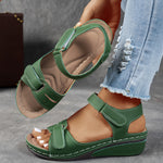 Green orthopedic comfort sandals with hook-and-loop straps and cushioned wedge sole
