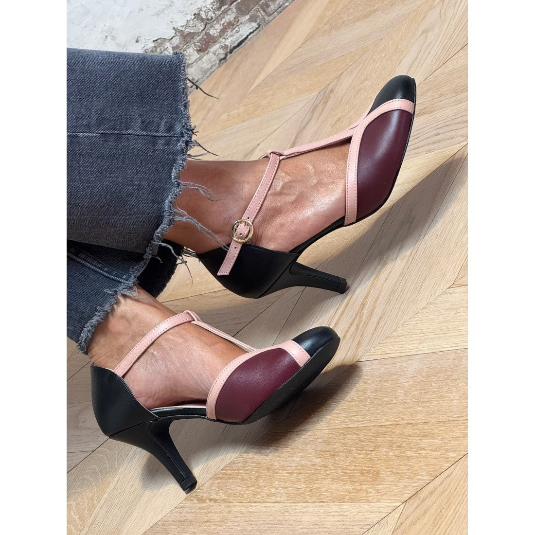 Two-tone T-bar pumps with burgundy uppers, blush straps, and black block heel
