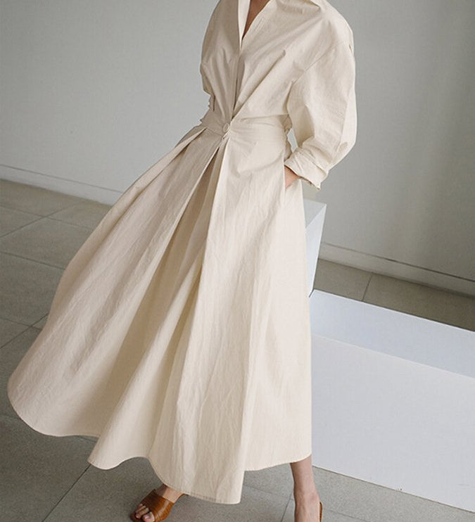 Beige long wrap-style dress with puff sleeves and tied waist, full skirt
