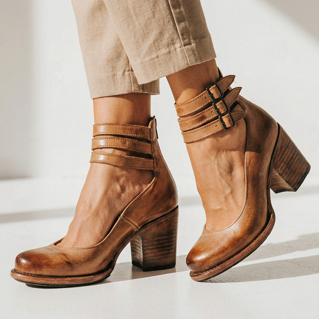 Pair of brown leather heeled ankle boots with double buckles and block heel