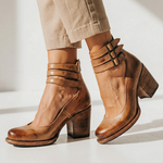 Pair of brown leather heeled ankle boots with double buckles and block heel