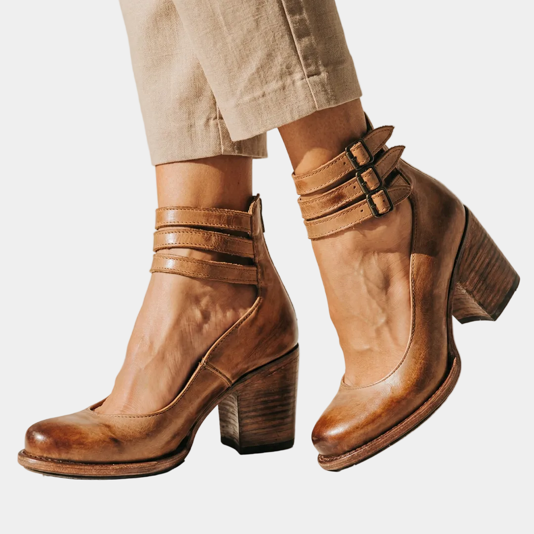 Brown leather heeled ankle boots with two strap buckles and chunky block heel