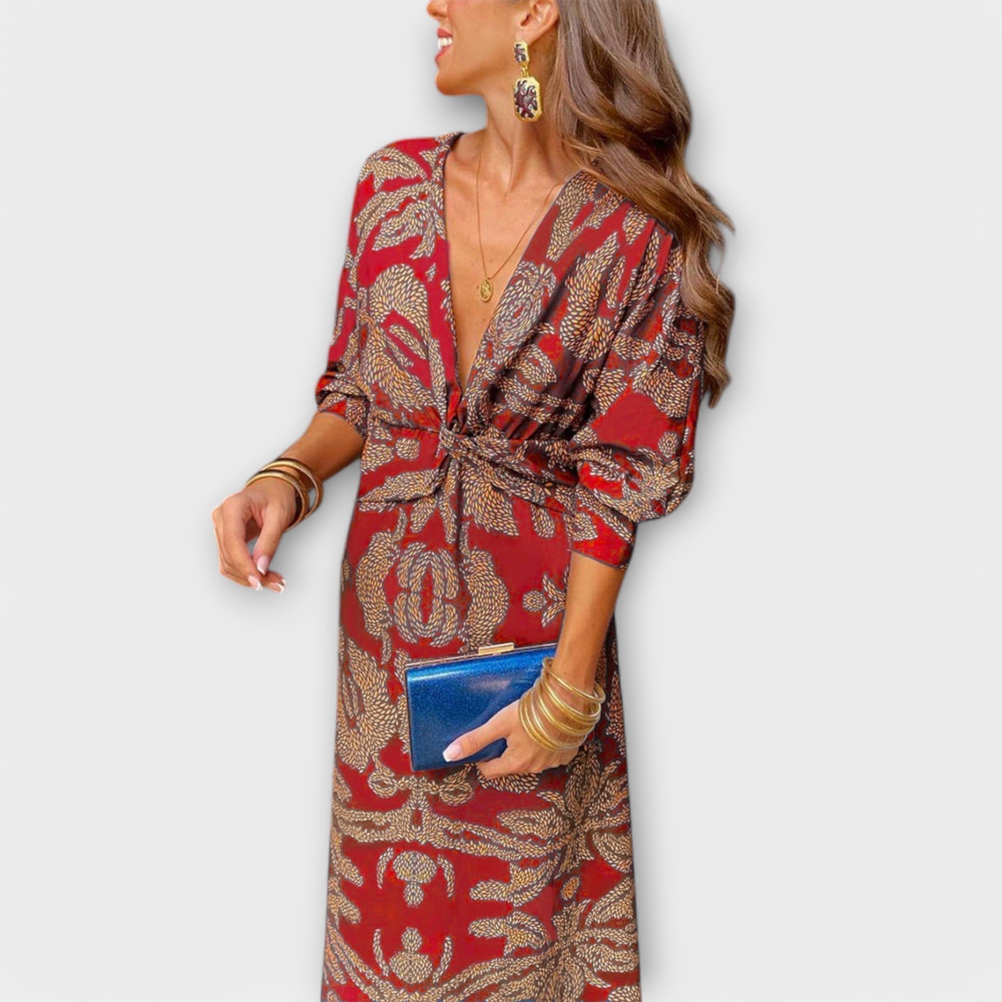 Elegant long-sleeve V-neck dress with red and gold ornate print, knotted waist tie