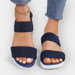 Comfort sandals with wide textured straps and open toe, dark navy upper, white platform sole.