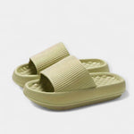 Pale yellow-green textured slide sandals with wide strap and thick sole