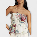 Floral strapless peplum top with gathered bust and ruffled waist, cream with multicolor print