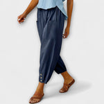 Navy blue harem pants with side pockets and button-tab cuffs, relaxed loose fit