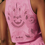 Pink lace sleeveless crop top with open back and embroidered floral motifs