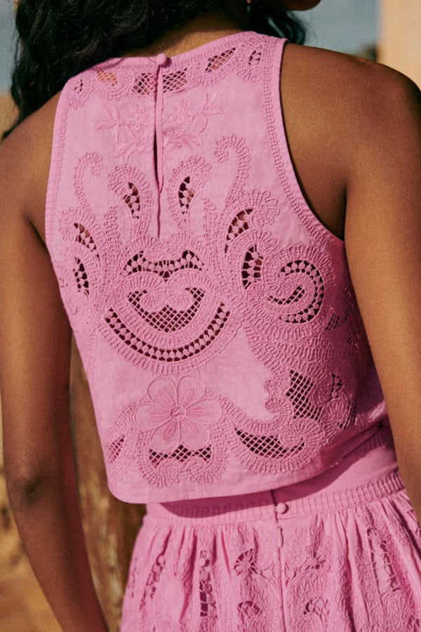 Pink lace sleeveless crop top with open back and embroidered floral motifs