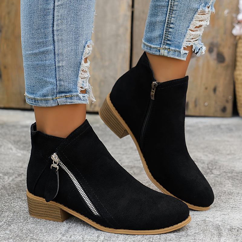 Black suede orthopedic ankle boots with side zip and low wooden block heel.