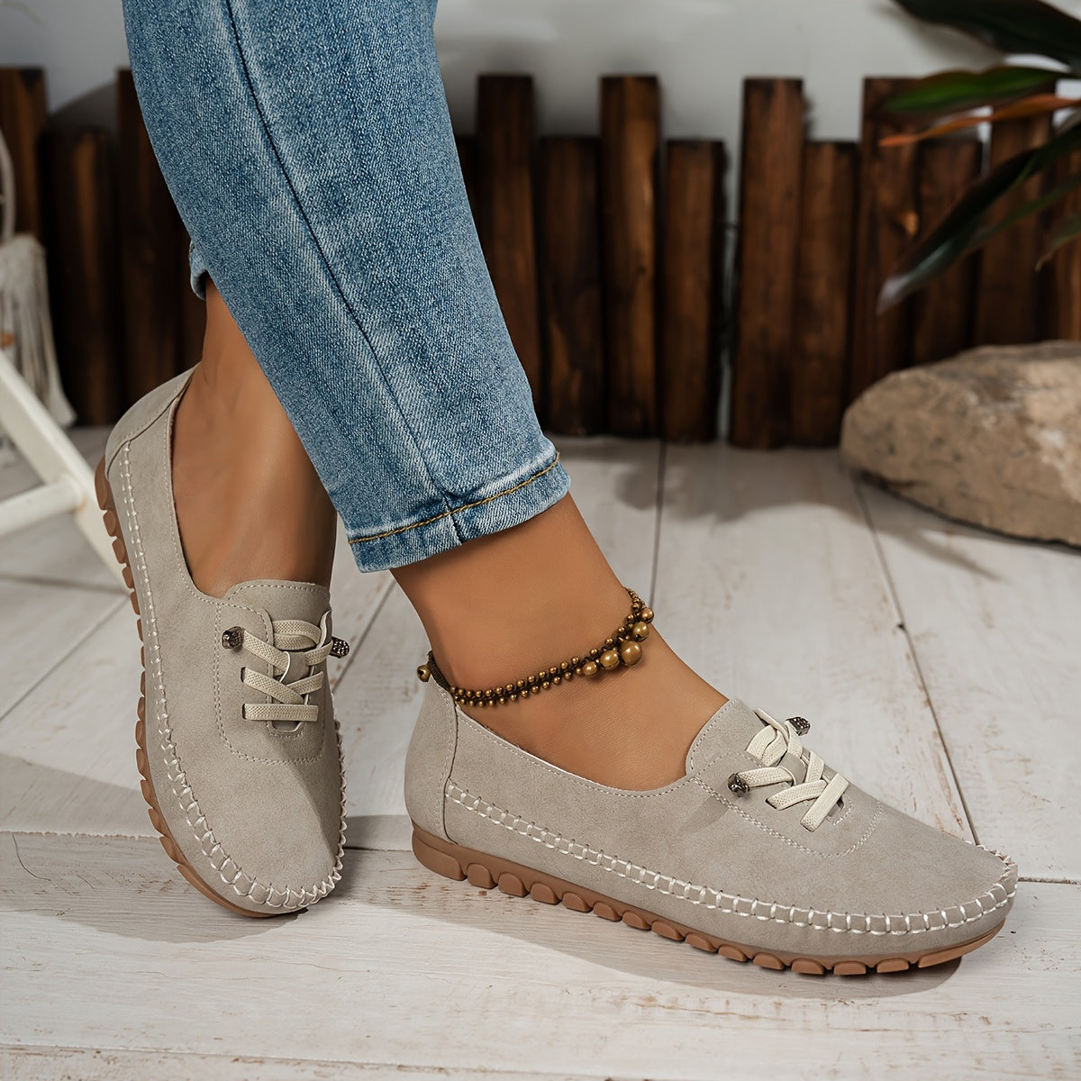 Beige suede-look slip-on loafer shoes with lace-up top and rubber tread sole