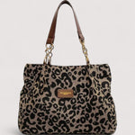 Leopard print shopping tote bag with brown leather handles and gold chain accents