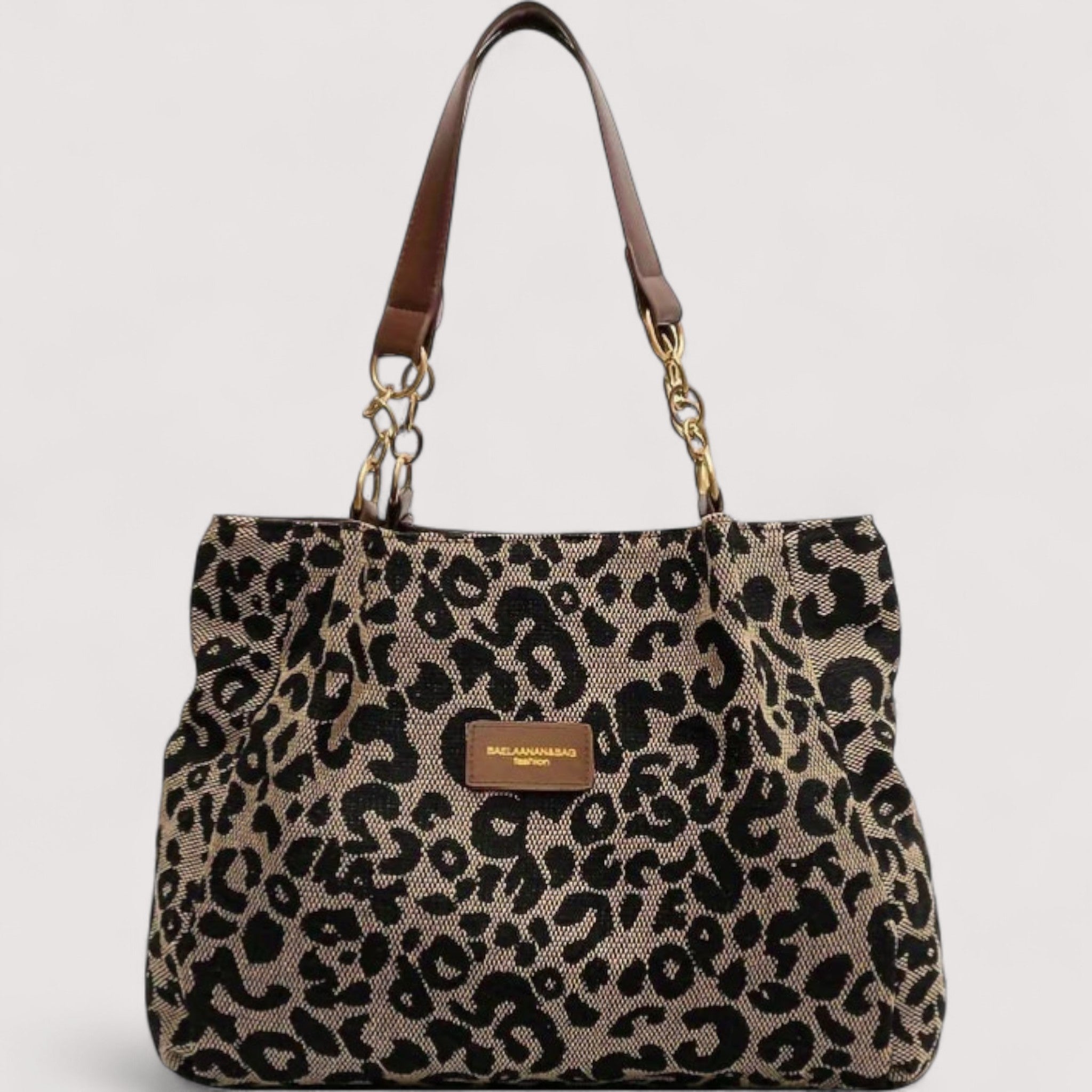 Leopard print shopping tote bag with brown leather handles and gold chain accents