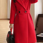 Red winter coat with notch lapels, waist belt, and front button closure