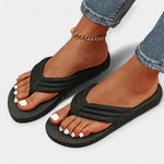 Black thong sandals with curved straps and cushioned sole