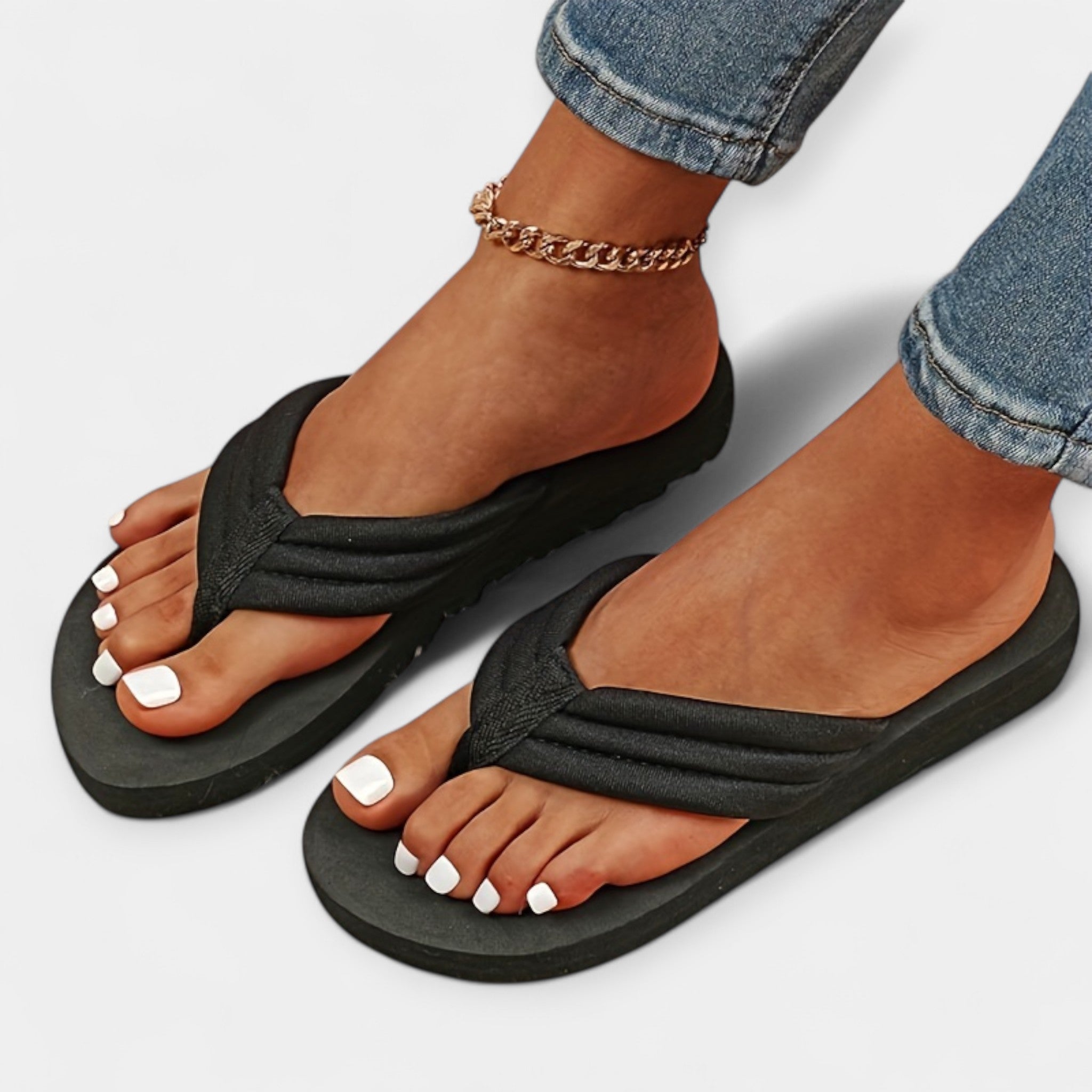 Black thong sandals with curved straps and cushioned sole