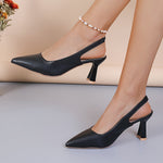 Black slingback pumps with pointed toe and mid block heel